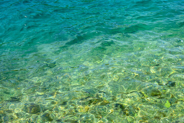 Fototapeta na wymiar Surface of the sea. Natural texture of sea water. Emerald ocean water background