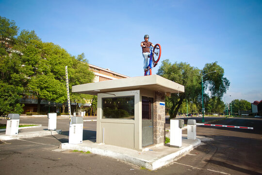 a man with a bike standing on the roof of a parking entrance in Mexico City, DF Mexico.