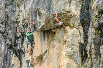 Man climbing rock, other slacklining, Dibs Quarry, Maripora, Sao Paulo State, Brazil