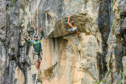 Man climbing rock, other slacklining, Dibs Quarry, Maripora, Sao Paulo State, Brazil
