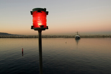 Red navigation light in a marina used to guide boat traffic, Redondo Beach, California.