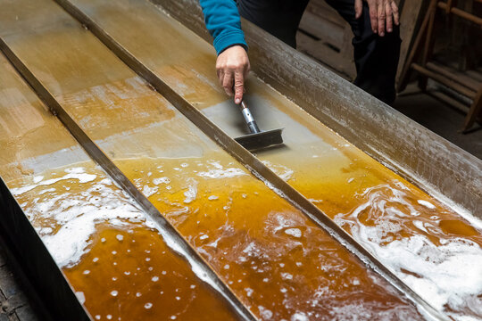 Man scraping maple syrup, Little&acirc;&euro;&nbsp;Suamico, Wisconsin, USA