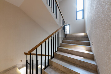 stairs in an apartment building with lighting and metal railings