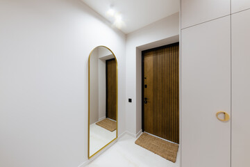 interior design of a light corridor with dark furniture in a new building