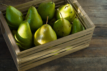 Pears on a wooden background. Fruit harvest. Autumn still life. Pear variety Bera Conference.