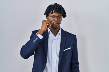 Young african man with dreadlocks wearing business jacket over white background mouth and lips shut...