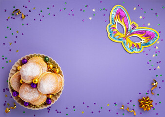 Mardi Gras King Cake Doughnuts or Donuts, Carnival Masks on Purple Background.