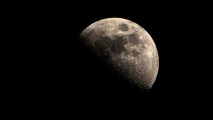 Half moon in the night sky. Close-up of the moon