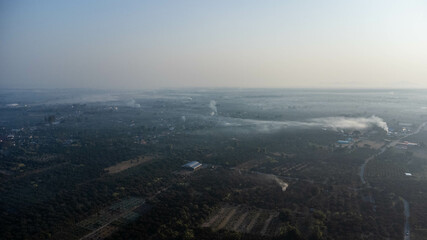 View of the horizon with smoke in countryside landscape. Rural air pollution.
