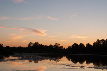 Fototapeta na wymiar View on lake under the shore in sunset light