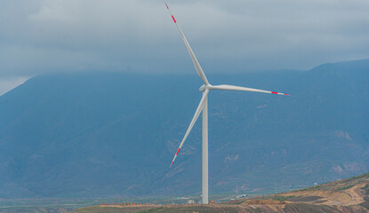 windmills or wind turbines that generate energy in the mountains