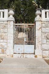 Old weathered wrought iron gate or door decorated with white terra cotta amphorae- seafront promenade in Hvar, Croatia