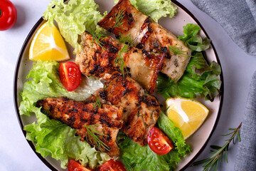 Grilled sturgeon pieces served with fresh lettuce, cherry tomato and lemon. Exquisite fish meal....