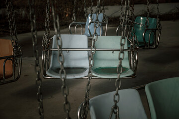 An old amusement ride in an abandoned amusement park. Abandoned carousel and cars. Sunny day. Old abandoned amusement park.