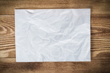 Sheet of paper lying on wooden table