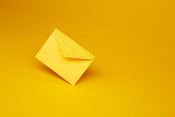 Yellow color paper office envelope for greeting or invitation with copy space isolated on the...