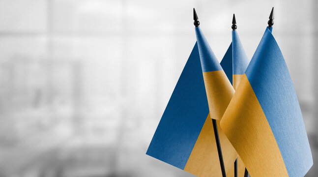 A small Ukraine flag on an abstract blurry background