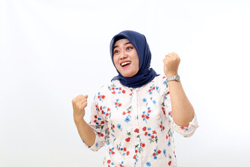 Excited asian muslim woman standing while celebrate her success. Isolated on white background