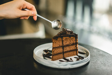 woman eating chocolate brownie cake