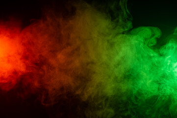 Fototapeta na wymiar Red yellow green smoke on a black background.