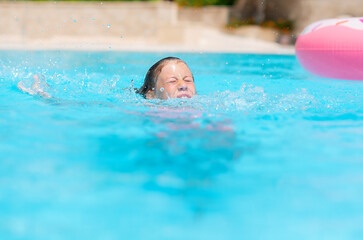 little girl deftly swim underwater in pool