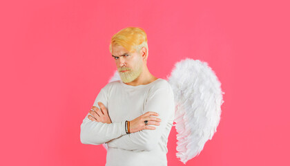 Valentines Day. Bearded man in angel wings with folded hands. Cupid in valentine day. Love concept.