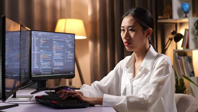 Asian Woman Programmer Creating Innovative Software Engineer Developing App, Program, Video Game On Desktop Computer At Home. Terminal With Coding Language 
