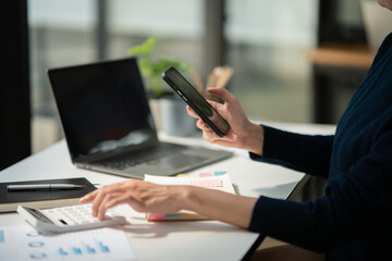 Asia businesswoman working on digital tablet executives meeting in an office using laptop...