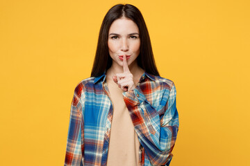 Young secret caucasian woman wear blue shirt beige t-shirt say hush be quiet with finger on lips...