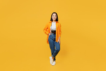 Young happy smiling fun cheerful woman wears summer casual clothes camera isolated on plain yellow background. Tourist travel abroad in free spare time rest getaway. Air flight trip journey concept.