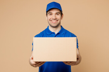 Professional smiling positive fun delivery guy employee man wear blue cap t-shirt uniform workwear...