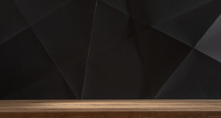 Wooden table with black paper on background