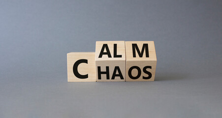 Calm vs chaos symbol. Turned wooden cubes with words Chaos and Calm. Beautiful grey background. Business and Calm vs chaos concept. Copy space.