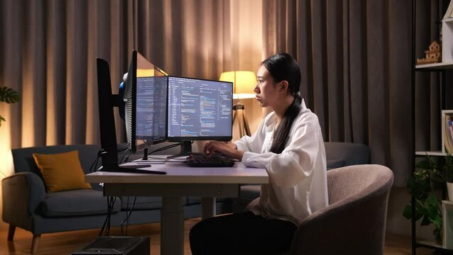 Asian Woman Programmer Creating Innovative Software Engineer Developing App, Program, Video Game On Desktop Computer At Home. Terminal With Coding Language 
