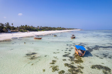 Aerial view of Kiwengwa beach in Zanzibar, Tanzania with luxury resort and turquoise ocean water. Toned image.