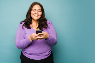 Excited fat woman sending text messages on social media