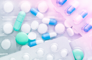 Colorful pills and capsules background close up, copy space, selective focus, medical concept.
