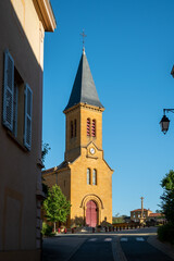 Wine making region Beaujolais Pierre dorees wioth yellow houses and hilly vineyards, sunny day in France