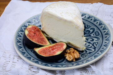 Delice de Bourgogne French cow's milk cheese from Burgundy region of France served with fresh figs and walnuts