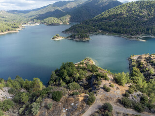 Fototapeta na wymiar Aerial view on freshwater lake with dam for irrigation and drinking in centre of dry, sunny Cyprus island