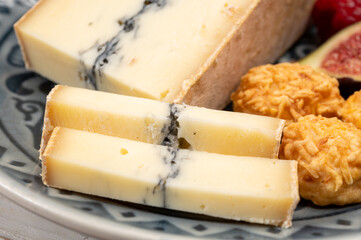 French semi-soft cow milk cheese morbier from Franche-Comte region with thin black layer and strong aroma
