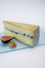 French semi-soft cow milk cheese morbier from Franche-Comte region with thin black layer and strong aroma