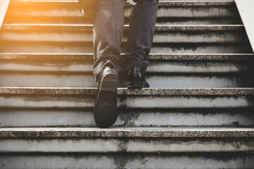 Step to success concept Sucessful business man walking up stairs Businessman with bags in his hands...