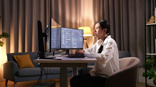 Asian Woman Programmer Yawning While Creating Innovative Software Engineer Developing App, Program, Video Game On Desktop Computer At Home. Terminal With Coding Language 
