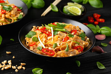 Chicken Pad Thai with eggs, bean sprouts, peanuts and spring onion