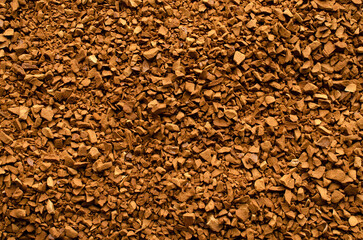 Background of instant coffee closeup, banner. Texture of instant coffee granules, top view. Instant...