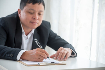 Close up manager businessman hands sign contract working meeting. Asian business man using pen signing on new contract to starting projects in conference room.  Business agreement concepts.