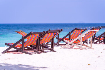 Matcheswooden chaise longue chairs on beach
