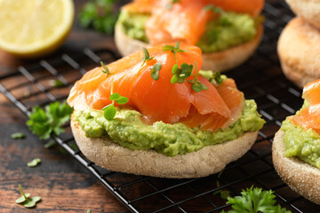 Fresh English Muffins with avocado and salmon. Healthy morning breakfast food