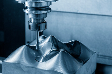 The CNC milling machine cutting injection sample part by solid ball end mill tool.